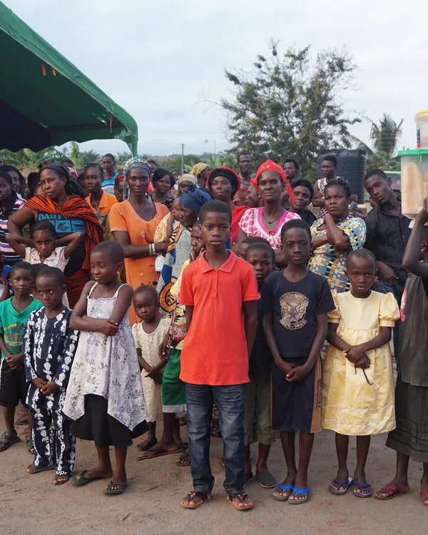 Children and mothers in a Ghanaian community — representing the families supported by Wildflower Medicine's charitable giving